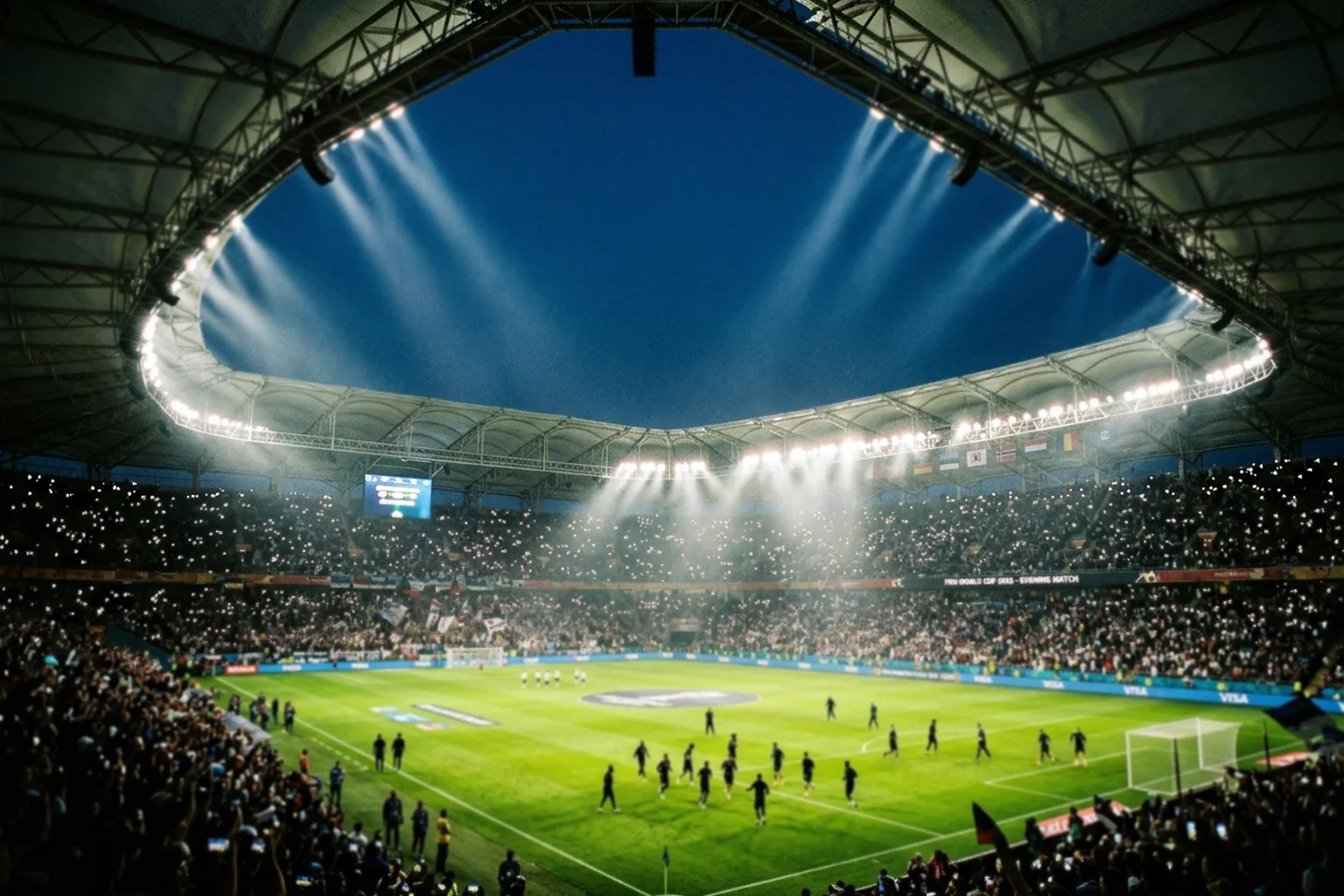 Esti stadionhangulat reflektorokkal megvilágított labdarúgópályán, a meccs előtti pillanatokban